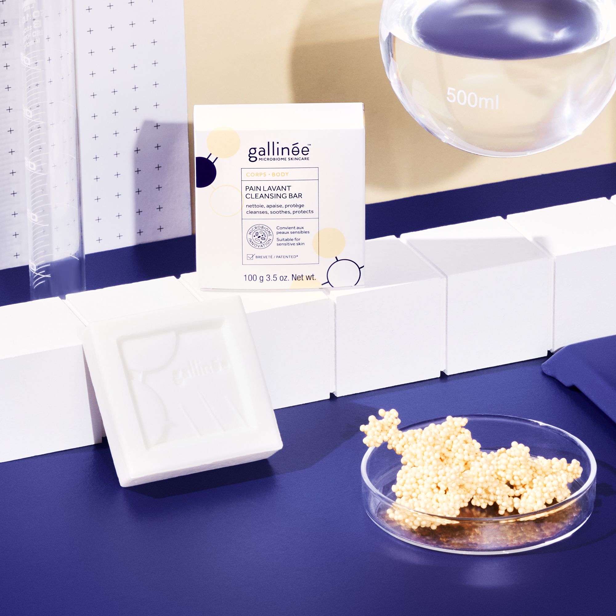 Emballage produit et savon sur fond bleu. Contient savon, emballage et matériel de laboratoire.