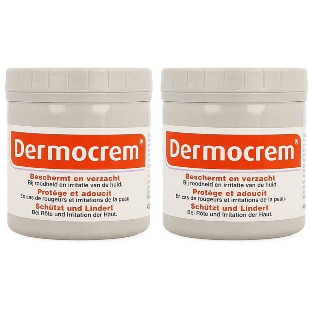 Twee potten crème met de merknaam Dermocrem. Opschrift: Beschermt en verzacht bij roodheid en irritatie van de huid. Grijze deksels.
