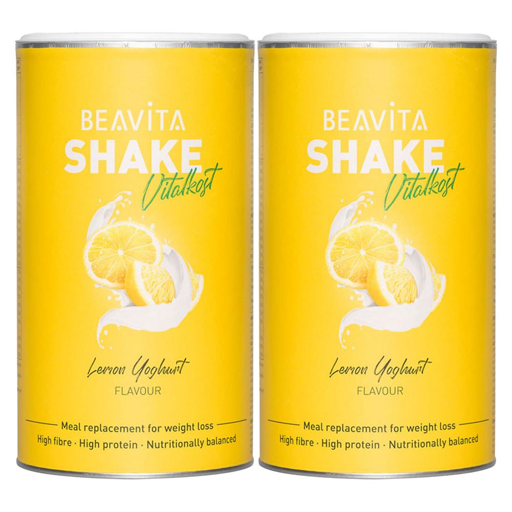 Twee gele blikken met etiket "BEAVITA SHAKE Vitalkost". Opdruk: Citroen-yoghurt, afbeelding van citroenen en melk. Tekst: Maaltijdvervanger voor gewichtsverlies.