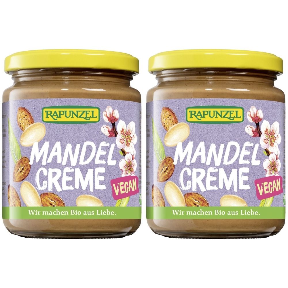 Deux pots de crème de amandes avec couvercles jaunes. Inscription: RAPUNZEL MANDEL CREME, vegan. Illustrations d'amandes et de fleurs.