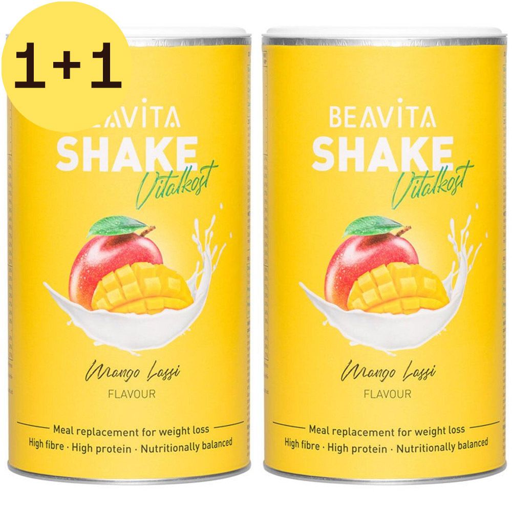 Twee gele blikken BEAVITA Shake Vitalkost, Mango Lassi, met 1+1 opdruk. Mango-afbeelding, tekst. "Meal replacement for weight loss".