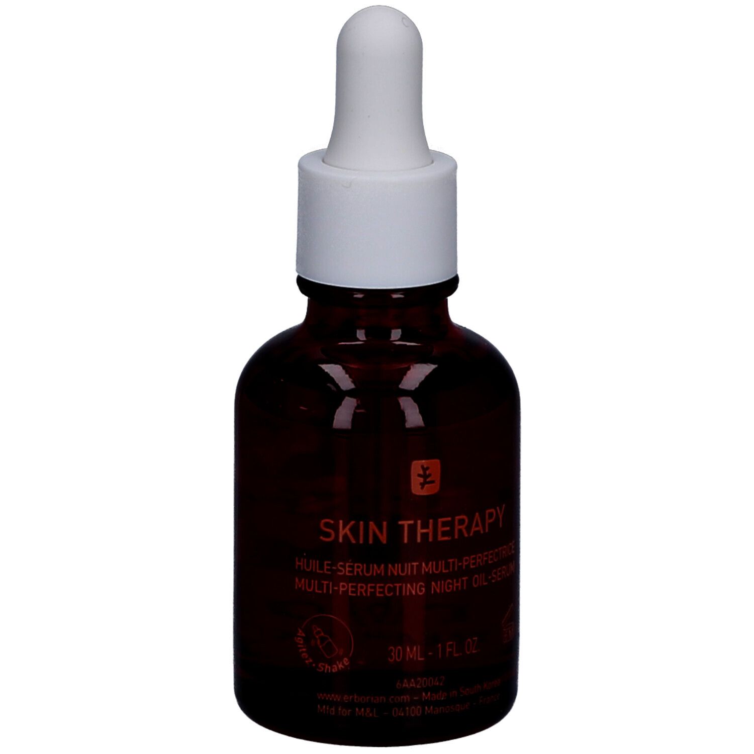 Bruine glazen fles met witte dop en pipet. Opschrift: Skin Therapy, nachtolie. Logo: boom.