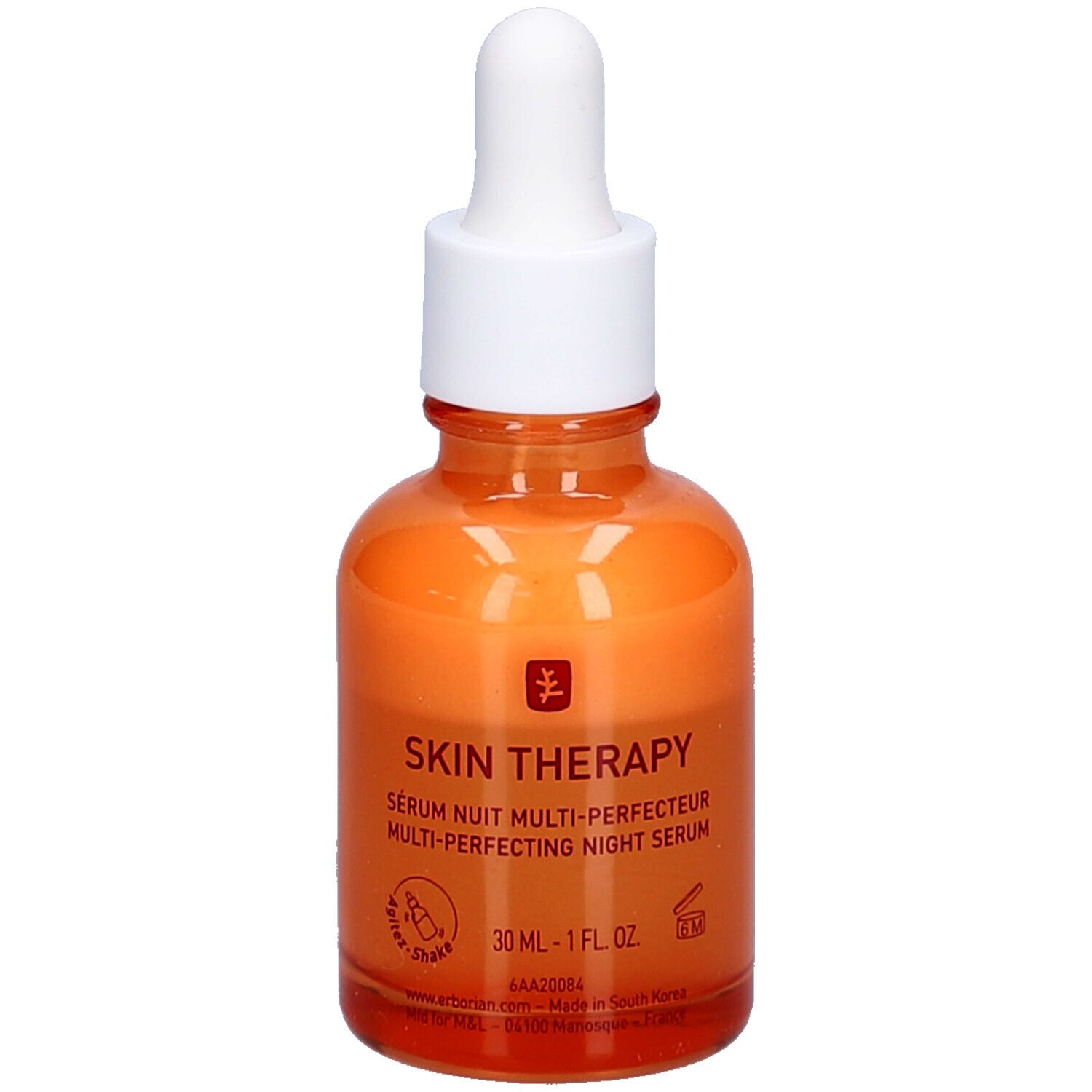 Oranje glazen fles met witte dop en pipet. Opschrift: Skin Therapy Serum Nuit Multi-Perfecteur.