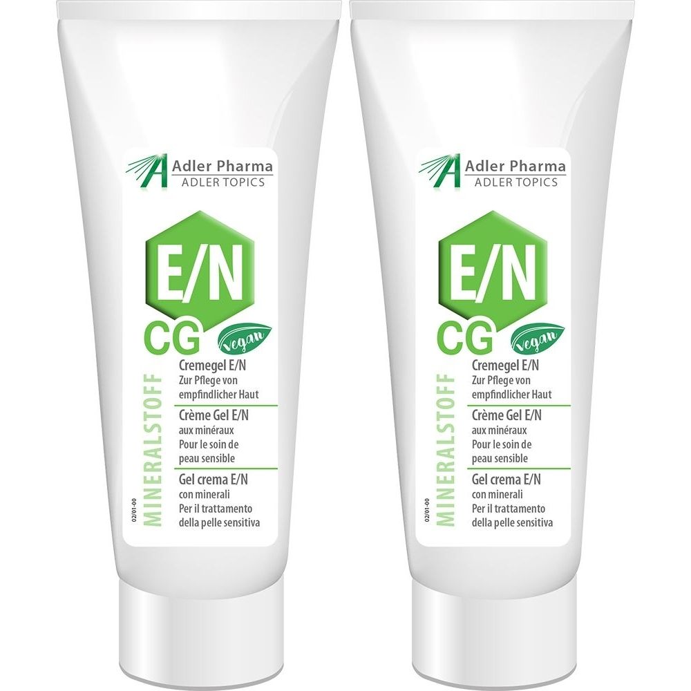 Twee witte crèmegel tubes met groene logo's en tekst. Opschrift: MINERALSTOFF, E/N CG, Adler Pharma. Vegan zegel.