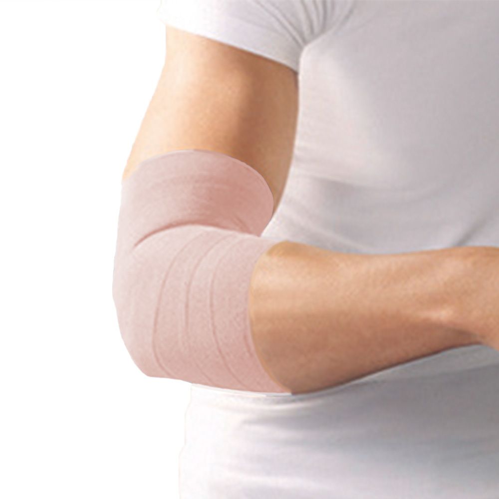 Bras avec bandage beige clair autour du coude. Le bandage est enroulé autour du coude.