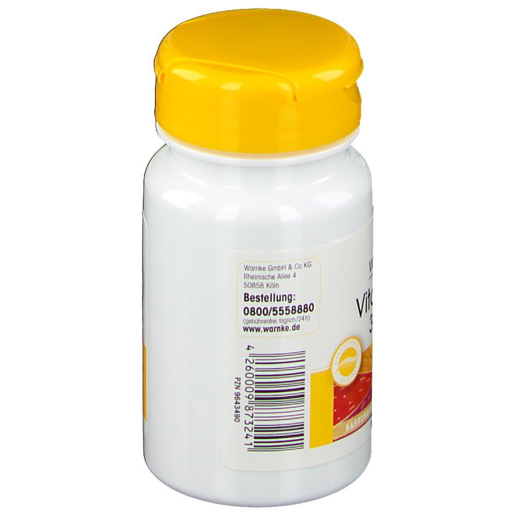 Witte fles met gele dop. Opschrift: WARNKE, bestelnummer, website. Tekstinformatie. Vitamine E, 36mg.