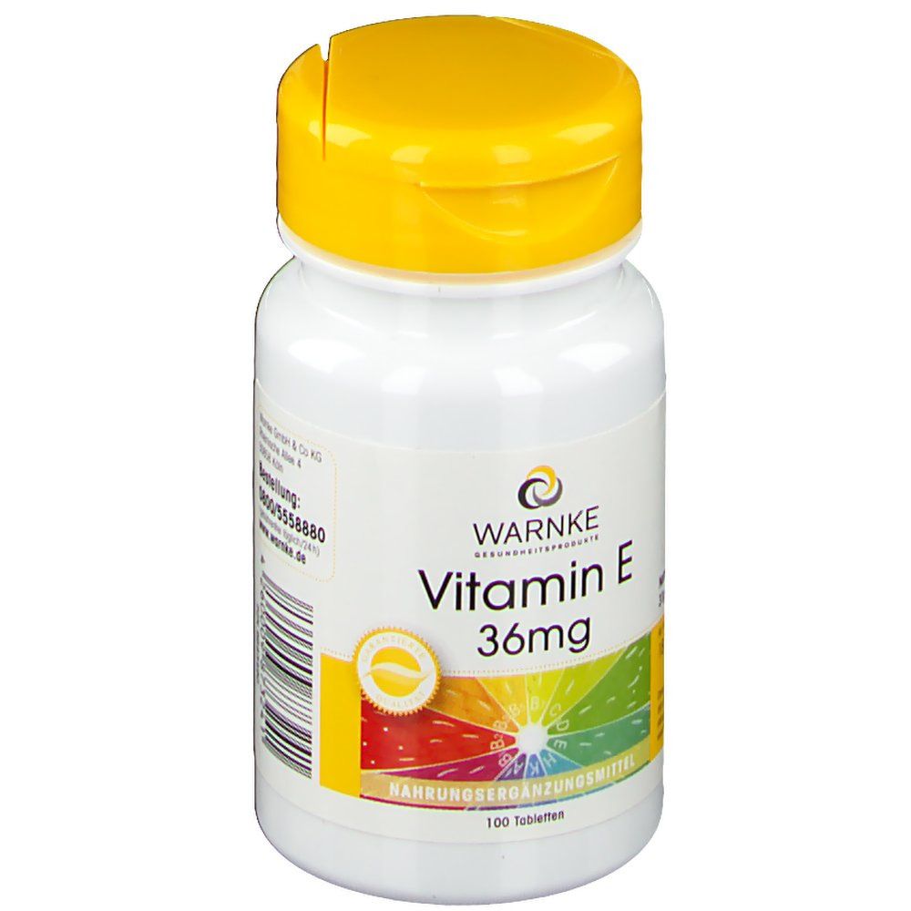 Witte fles met gele dop. Opschrift: WARNKE Vitamine E 36mg. 100 tabletten. Voedingssupplement. Logo.