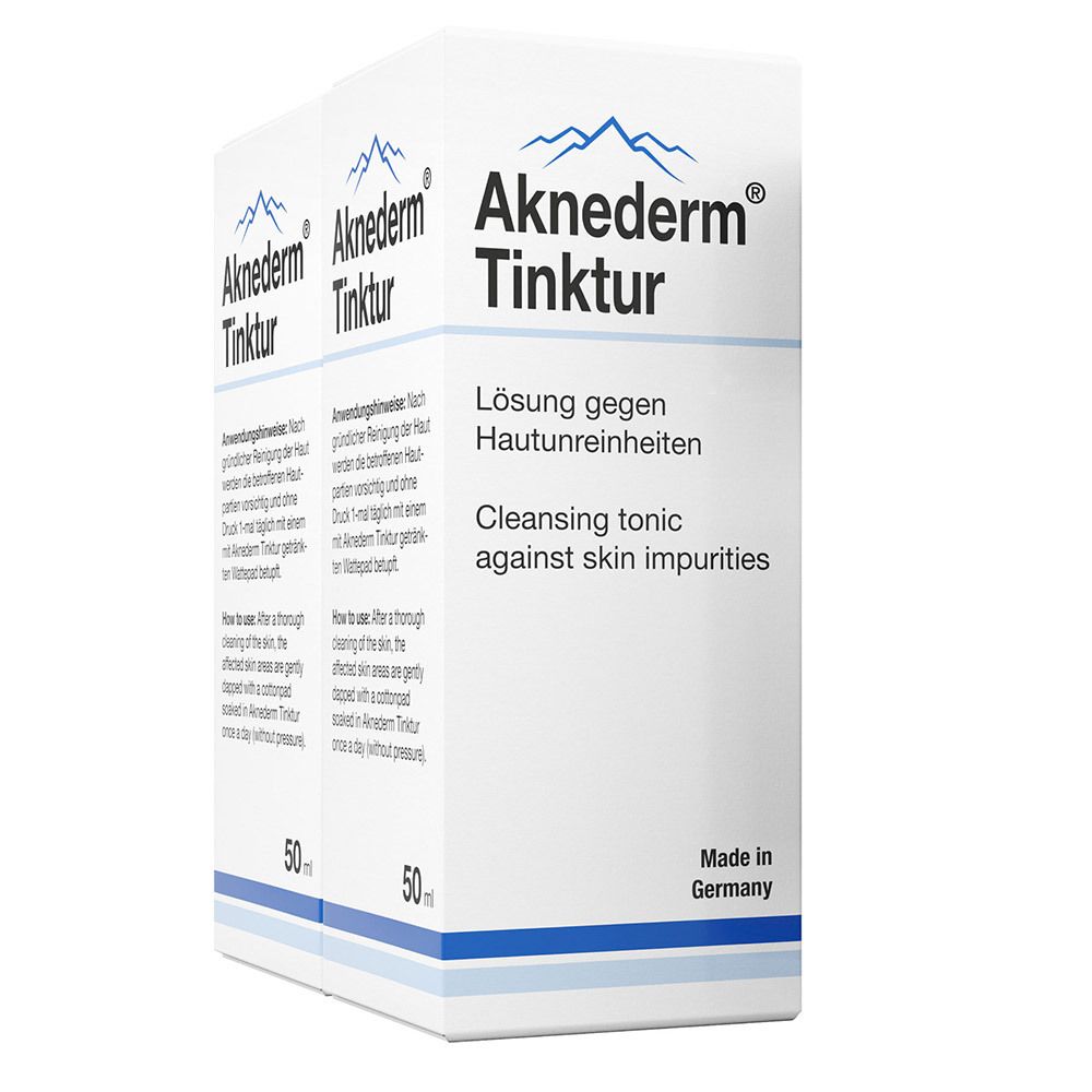 Twee verpakkingen Aknederm Tinktur. Witte verpakking met productnaam en tekst. 50 ml. Made in Germany.