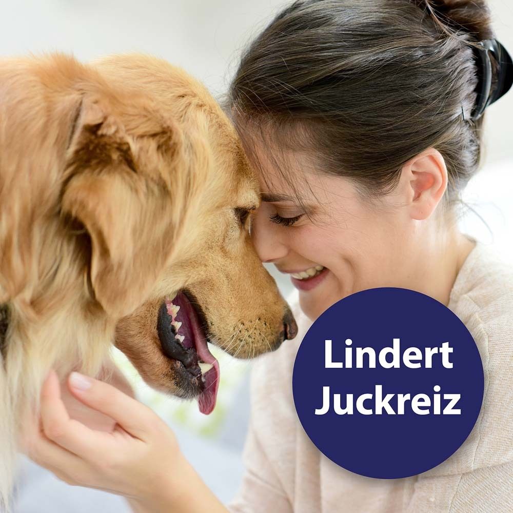 Vrouw en hond met hun voorhoofden tegen elkaar. Blauwe cirkel met tekst "Lindert Juckreiz".