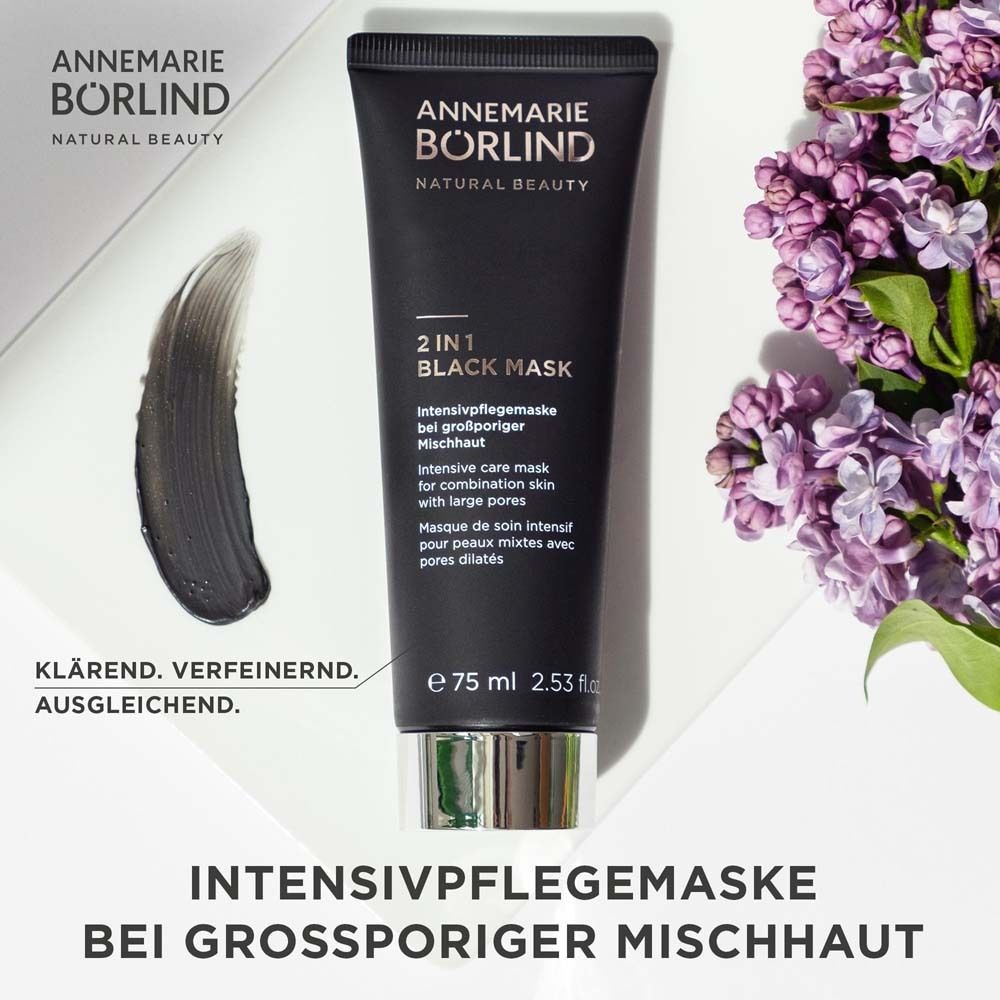 Zwarte tube met producttekst. Merk: ANNEMARIE BÖRLIND. Product: 2 IN 1 BLACK MASK. Tekst en bloemen.