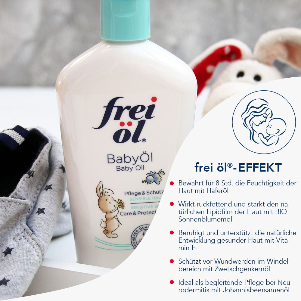 Flacon frei Öl® Baby Öl. Texte: frei Öl®-Effekt, ingrédients. En arrière-plan: jouets, textiles.