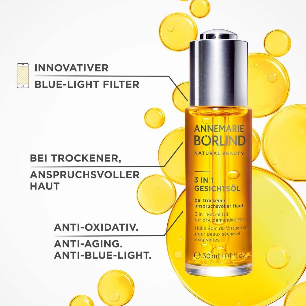 Gezichtsolie fles met tekst en gele druppels. Tekst: ANNEMARIE BÖRLIND, 3 in 1 Gezichtsolie. Anti-aging, anti-blauw licht.