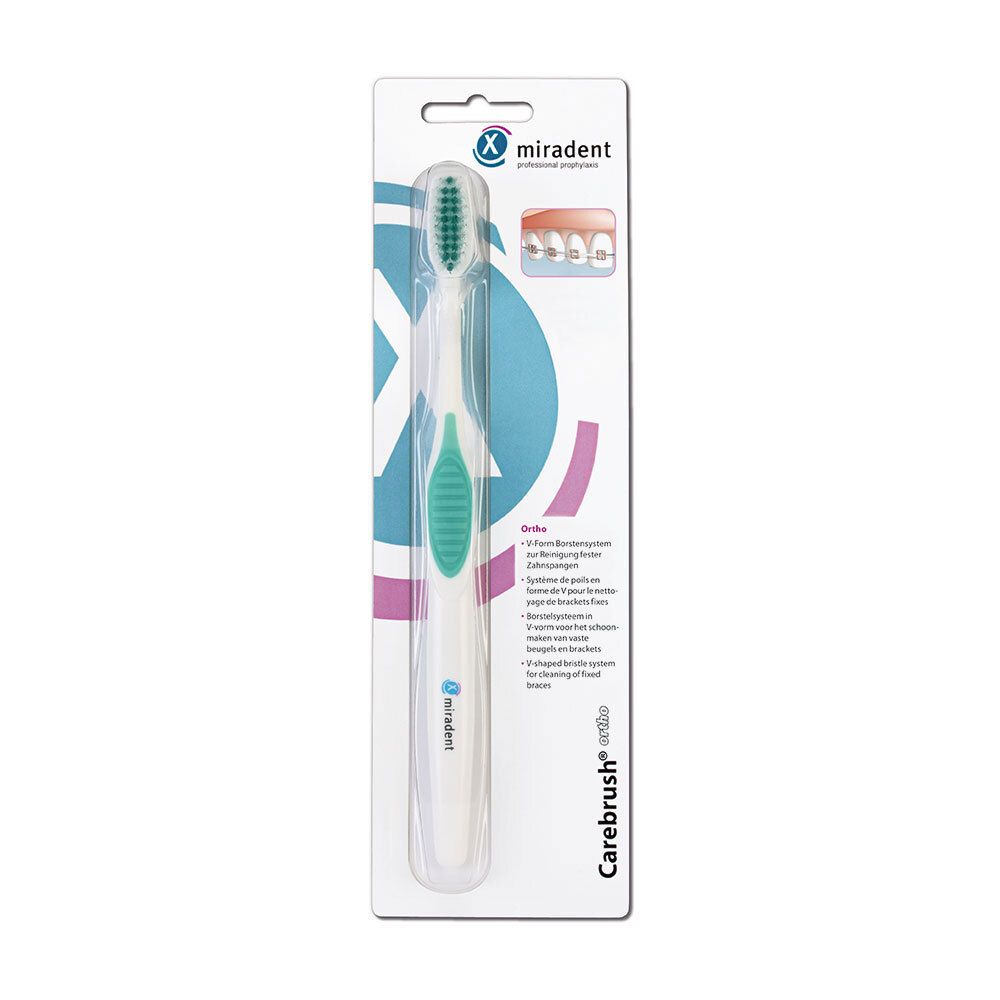 Brosse à dents pour porteurs d'appareils orthodontiques, emballée. Manche blanc, insert vert. Soies vertes. Marque et nom du produit visibles.