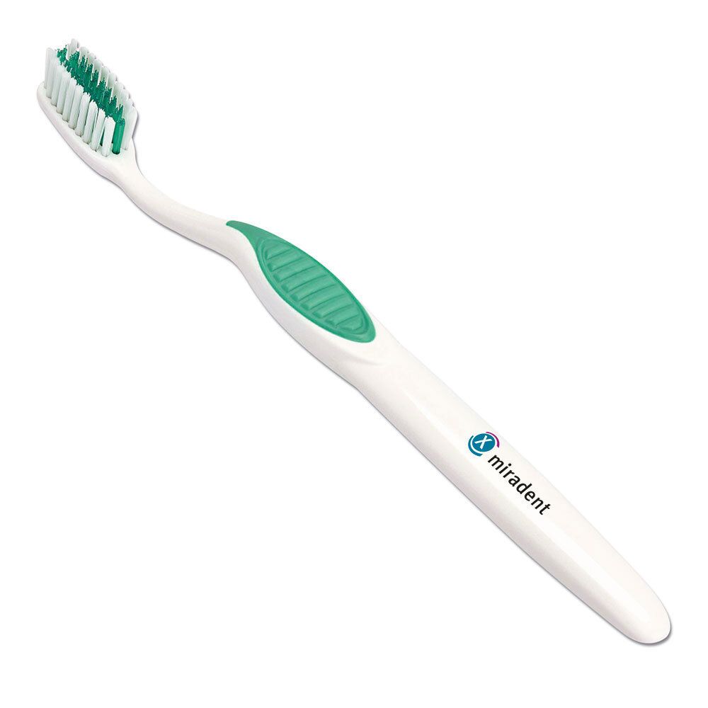 Brosse à dents pour appareils orthodontiques. Manche blanc, insert vert. Soies vertes. Marque visible sur le manche.