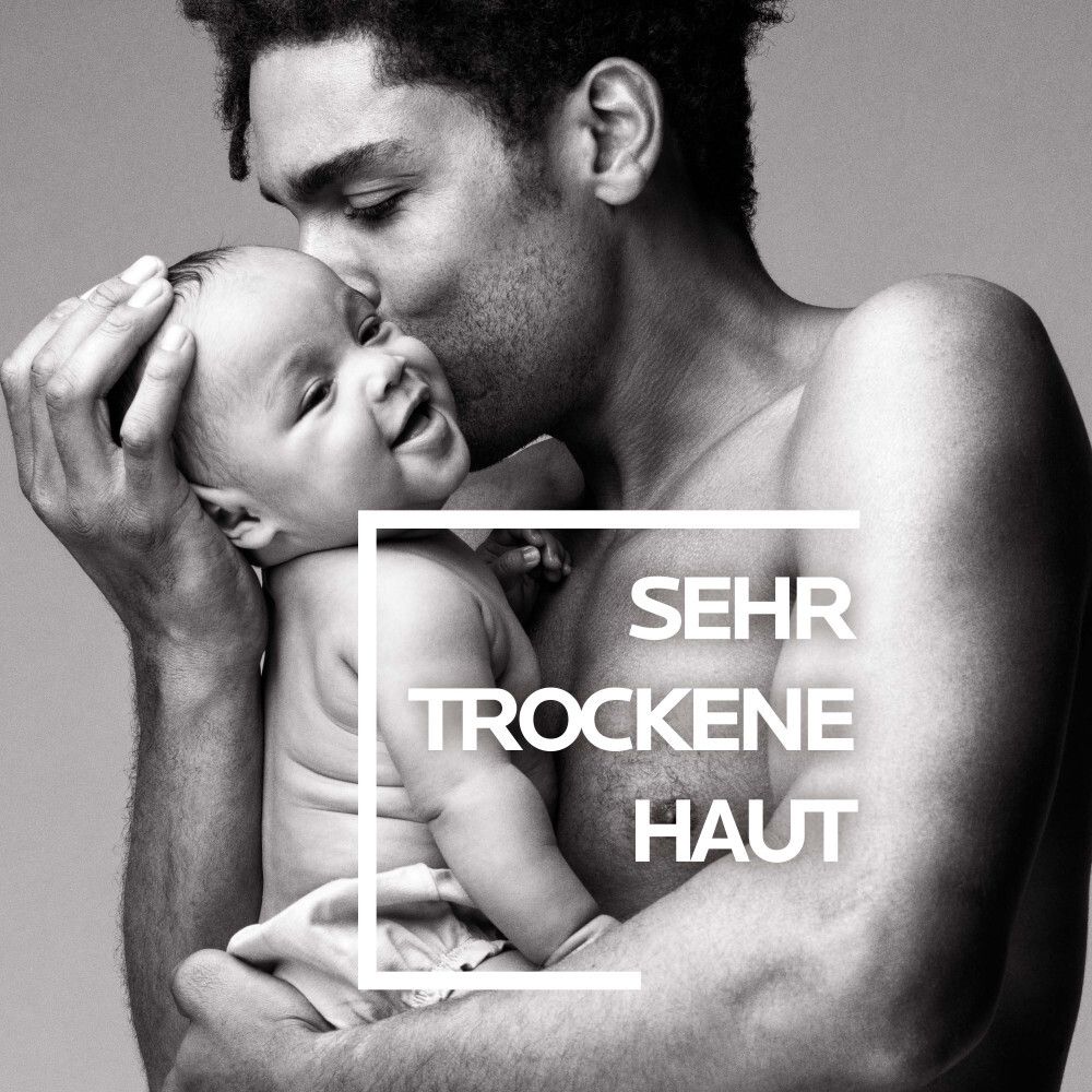 Homme tenant un bébé: La Roche Posay pour peau très sèche.