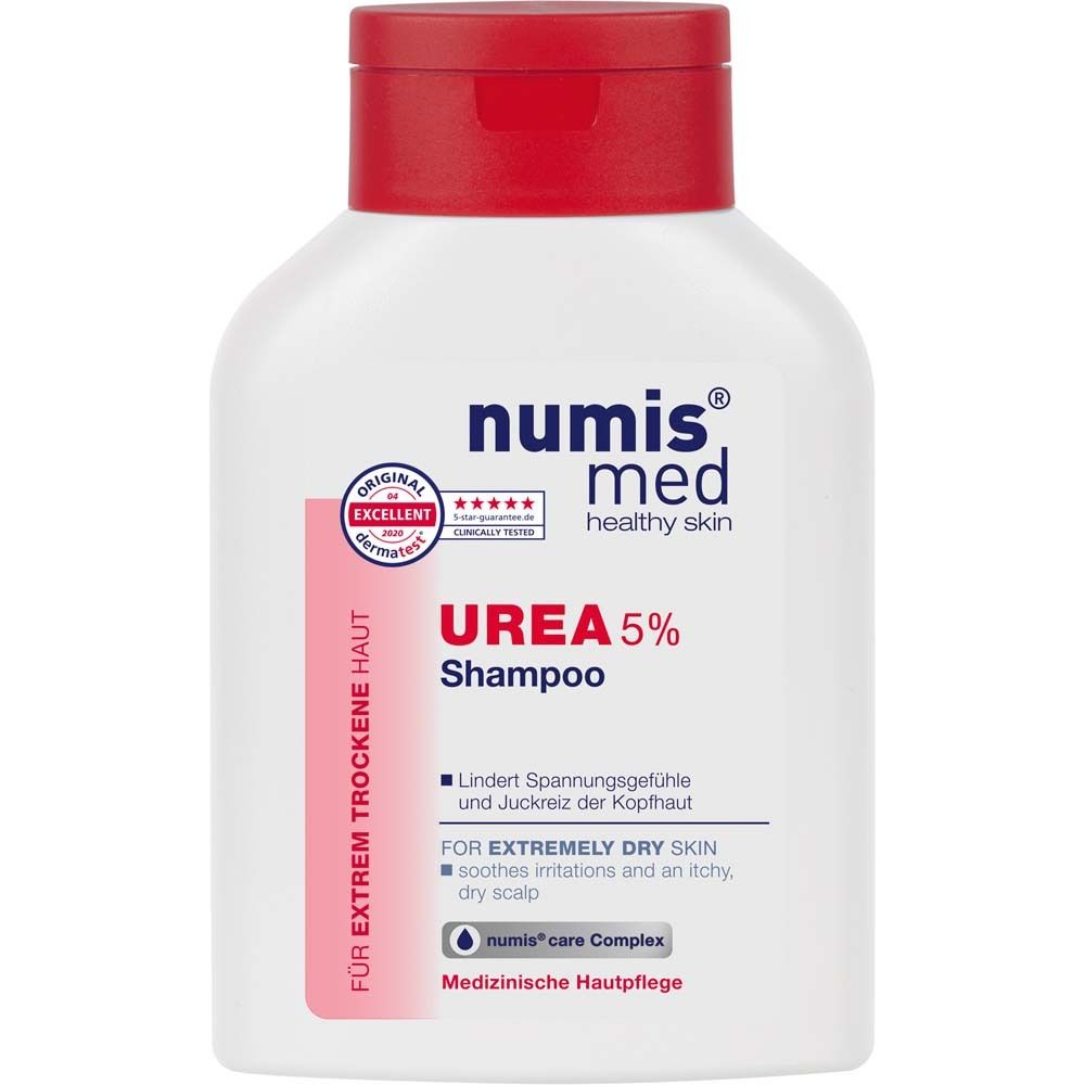 Flacon blanc à bouchon rouge. Inscription : numis med UREA 5% Shampoo. Pour peaux très sèches. Testé dermatologiquement.