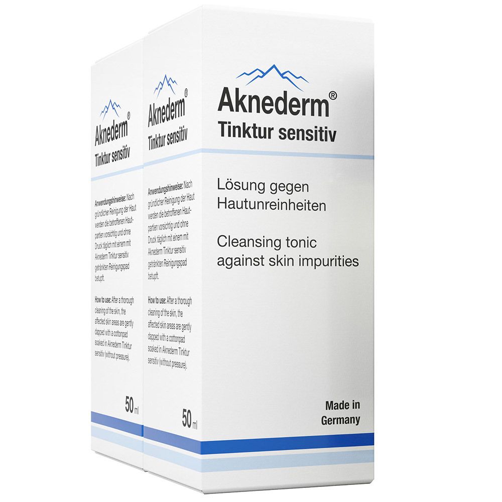 Deux boîtes blanches Aknederm® Tinktur sensitiv. Texte: Solution contre les impuretés cutanées, 50 ml.