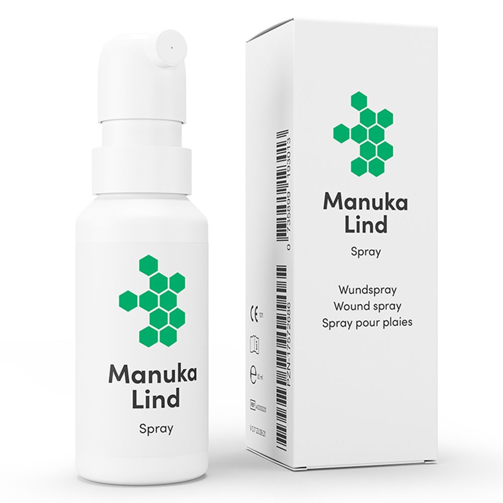 Witte sprayfles en doos met groen logo en tekst Manuka Lind Spray. Verpakking met wondspray-instructies.