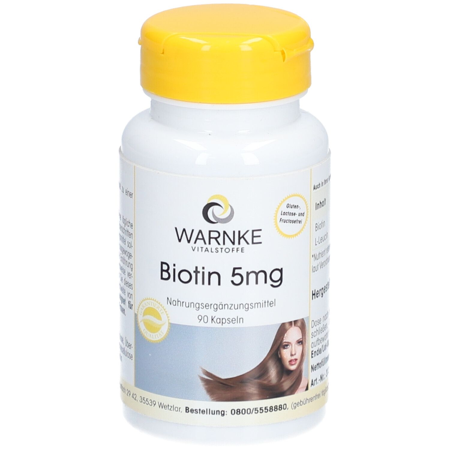 Flacon blanc à bouchon jaune. Inscription: Warnke Vitalstoffe, Biotin 5mg, 90 gélules. Image d'une femme aux cheveux longs.