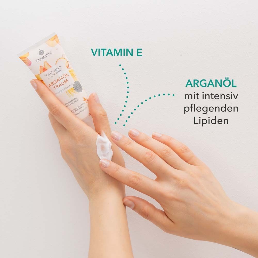 Handen met crème. Tekst: Vitamine E, arganolie met intensief verzorgende lipiden. Crèmetube op de achtergrond.