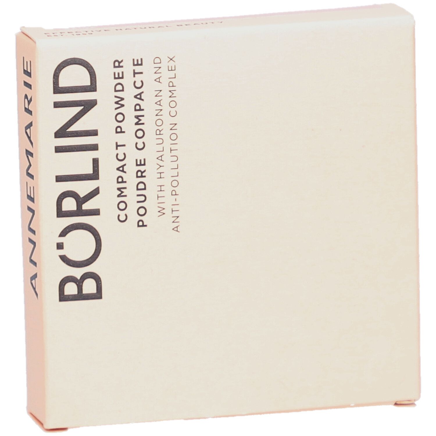 Boîte de poudre compacte. Carton beige avec le texte ANNEMARIE BÖRLIND. Texte: Compact Powder, Poudre Compacte, avec Hyaluron et Anti-Pollution Complex.