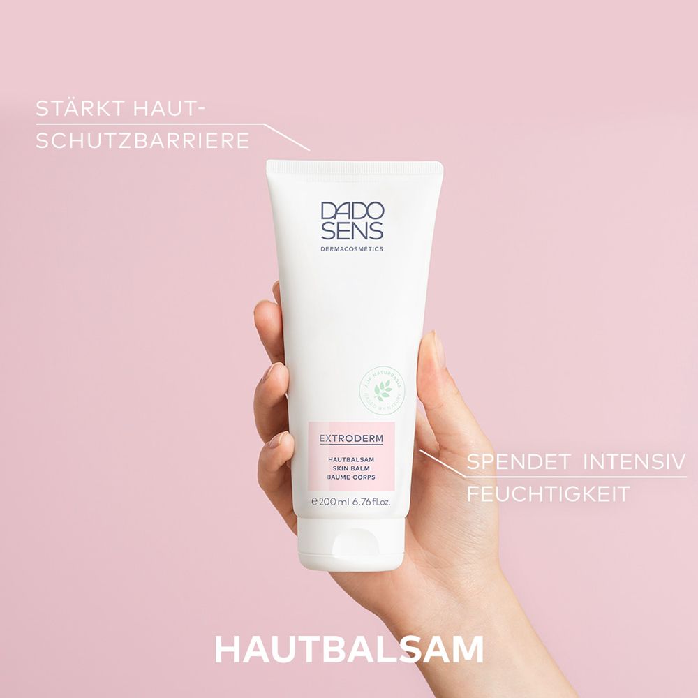 Baume blanc en tube. Main tenant le tube. Texte : 'STÄRKT HAUTSCHUTZBARRIERE'.