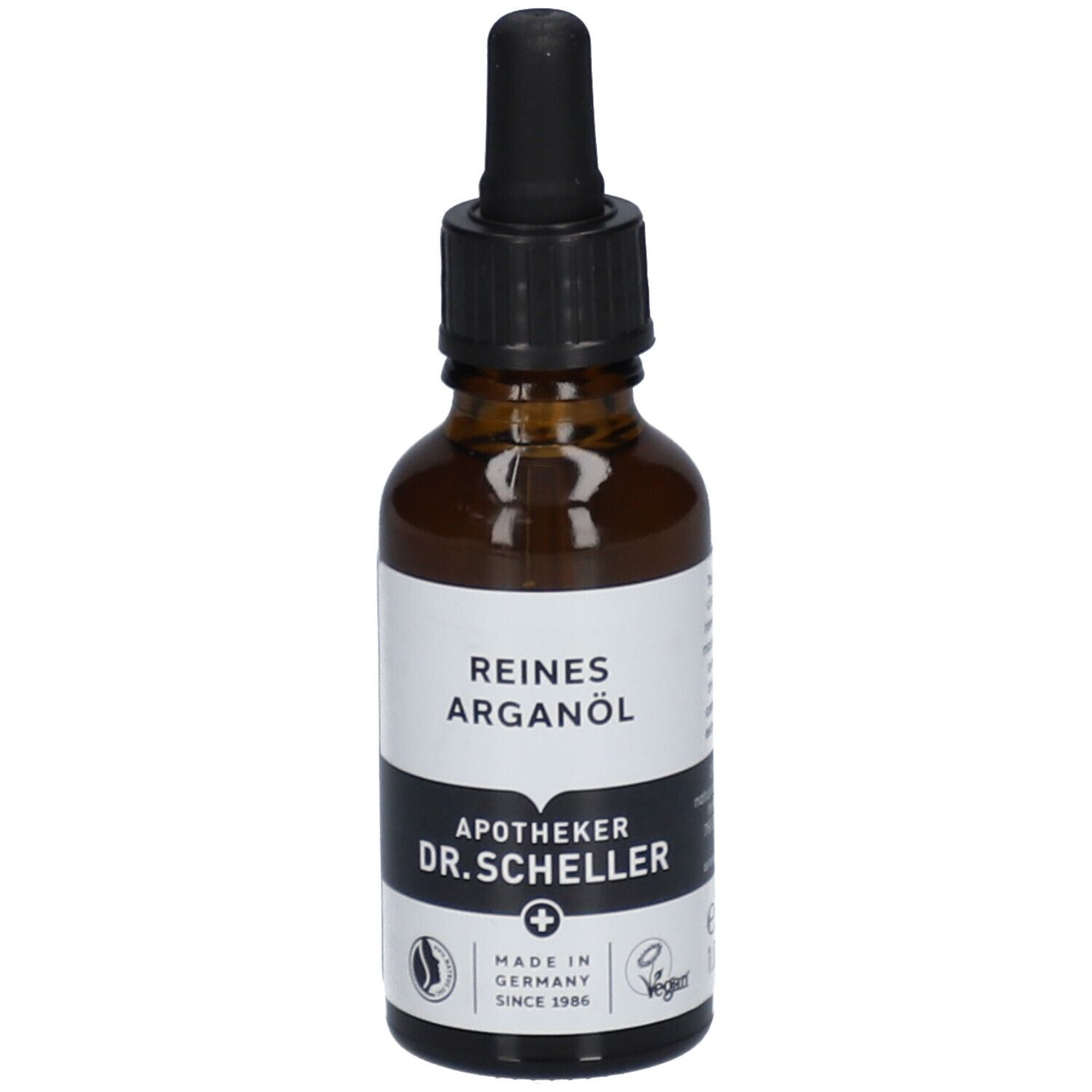 Bruine glazen fles met zwarte dop en pipet. Etiket met "REINES ARGANÖL" en "APOTHEKER DR.SCHELLER".