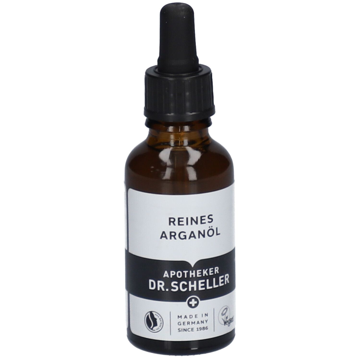 Bruine glazen fles met zwarte dop en pipet. Etiket met "REINES ARGANÖL" en "APOTHEKER DR.SCHELLER".