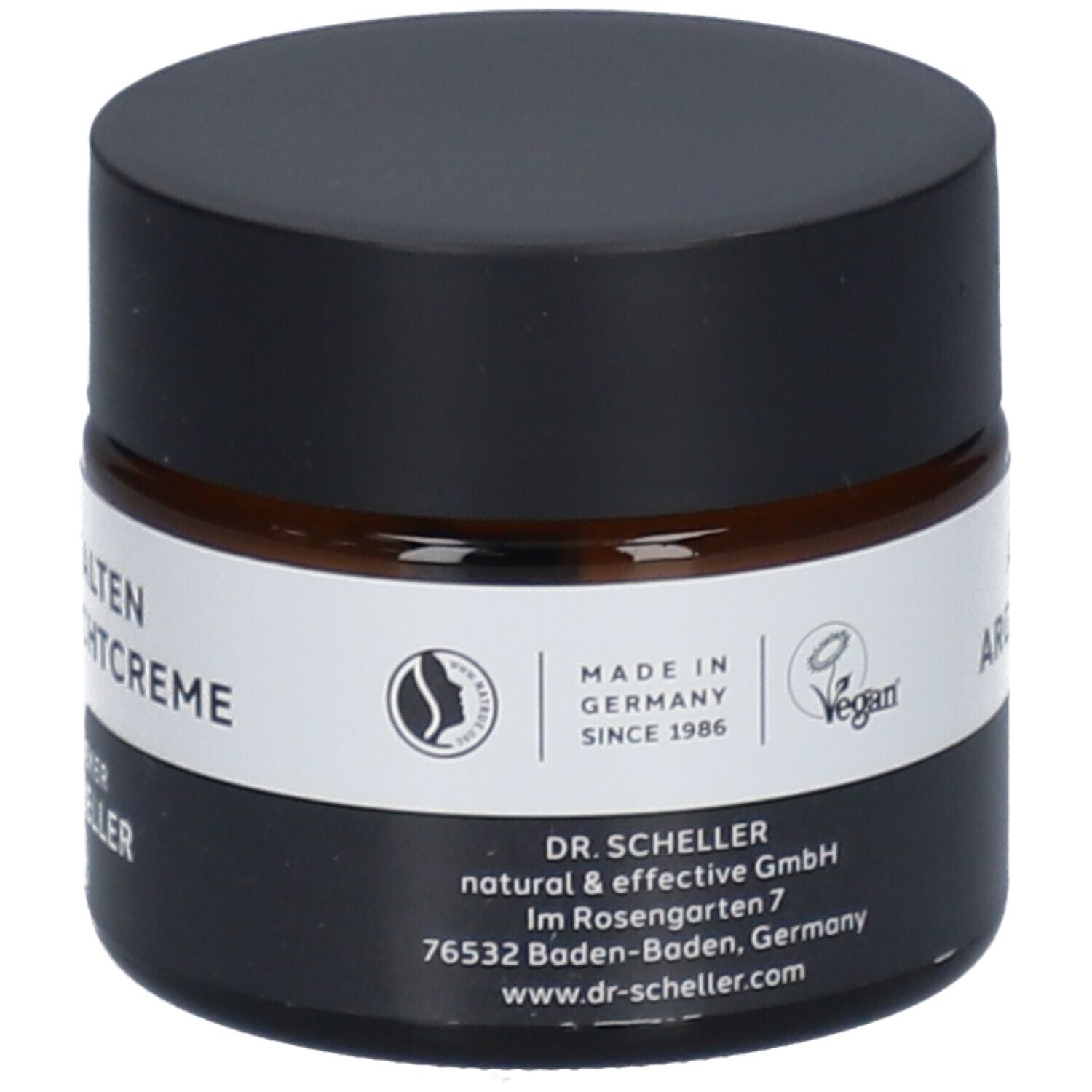 Pot de crème de nuit anti-rides. Verre brun, couvercle noir. Étiquette blanche avec nom du produit.