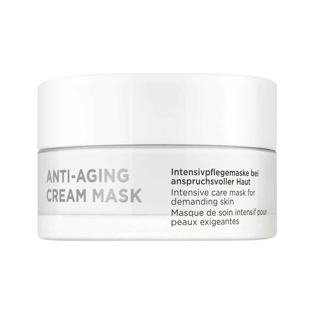 Witte crème mask in een witte pot. Opschrift: ANTI-AGING CREAM MASK. Tekst in het Duits, Engels en Frans.