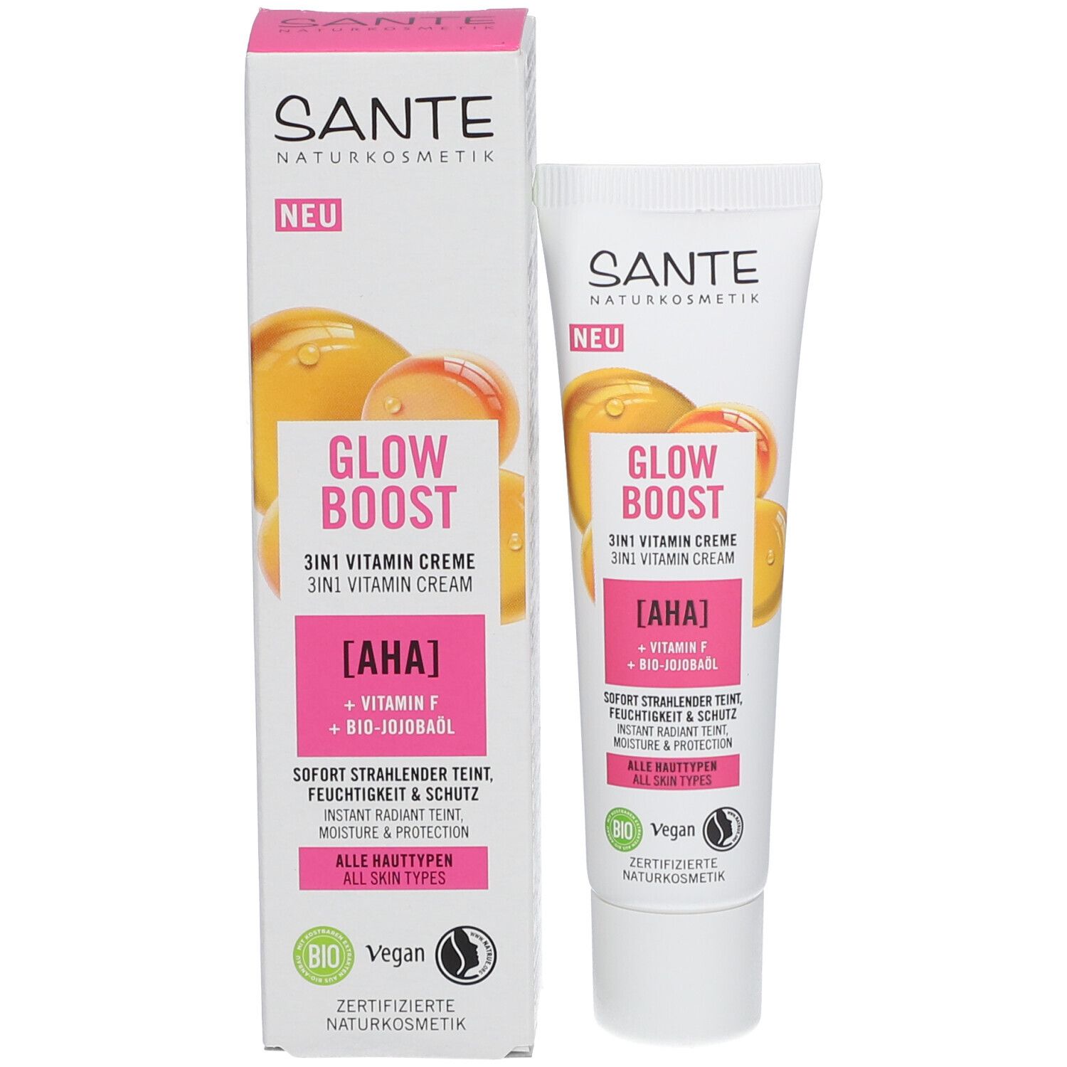 Tube et emballage de crème SANTE GLOW BOOST. Inscription : GLOW BOOST 3in1 Vitamin Creme. Contient AHA, Vitamine F, huile de jojoba bio. Tous types de peau.
