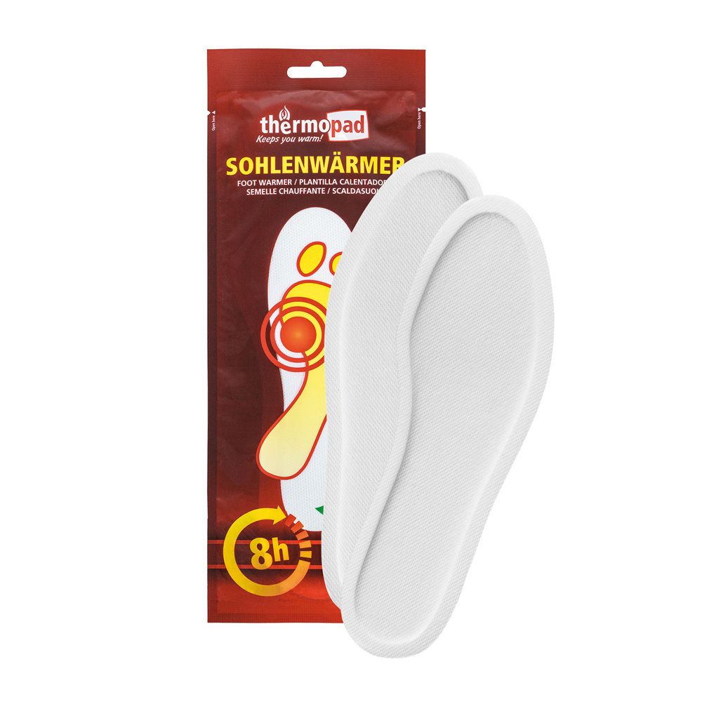 Twee witte zoolwarmers naast rode verpakking. Opschrift: thermopad, Sohlenwärmer, 8h.