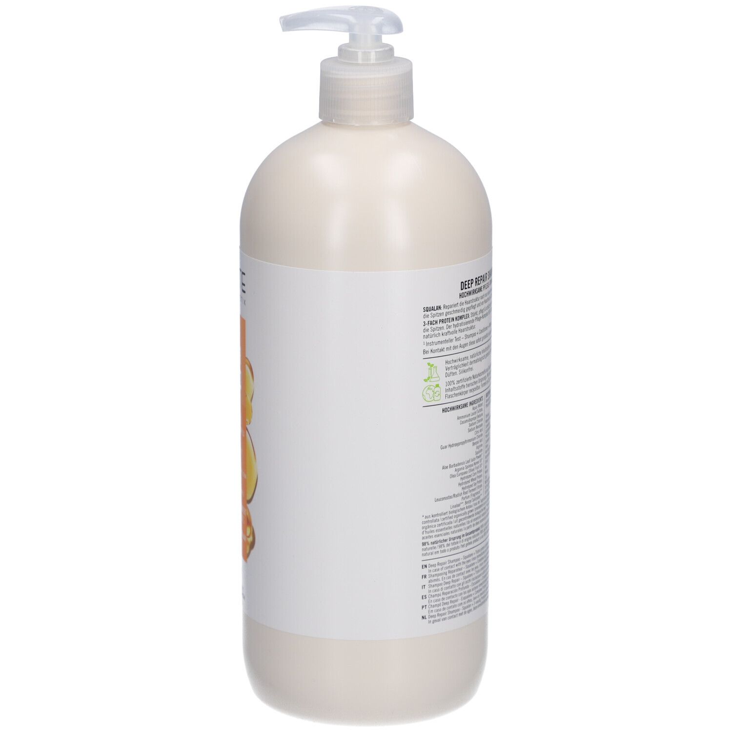 Flacon de shampooing beige avec pompe. Dos avec texte et logos. Contient 950 ml.