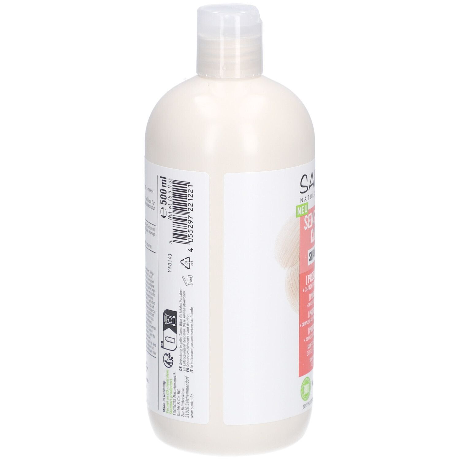 Achterkant van een beige shampoo fles met witte dop. Tekst en symbolen op wit etiket. Volume: 500 ml.