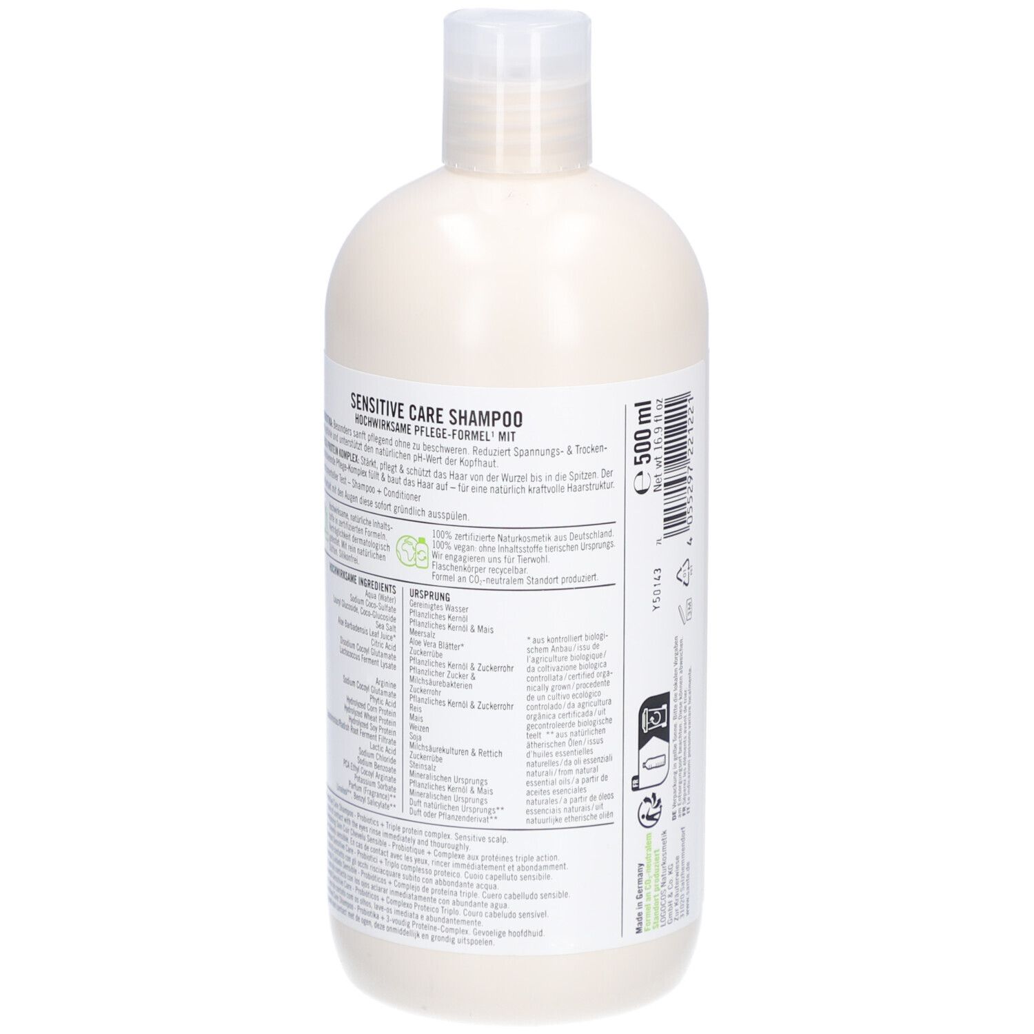 Achterkant van een beige shampoo fles met witte dop. Tekst op wit etiket. Ingrediënten en informatie.
