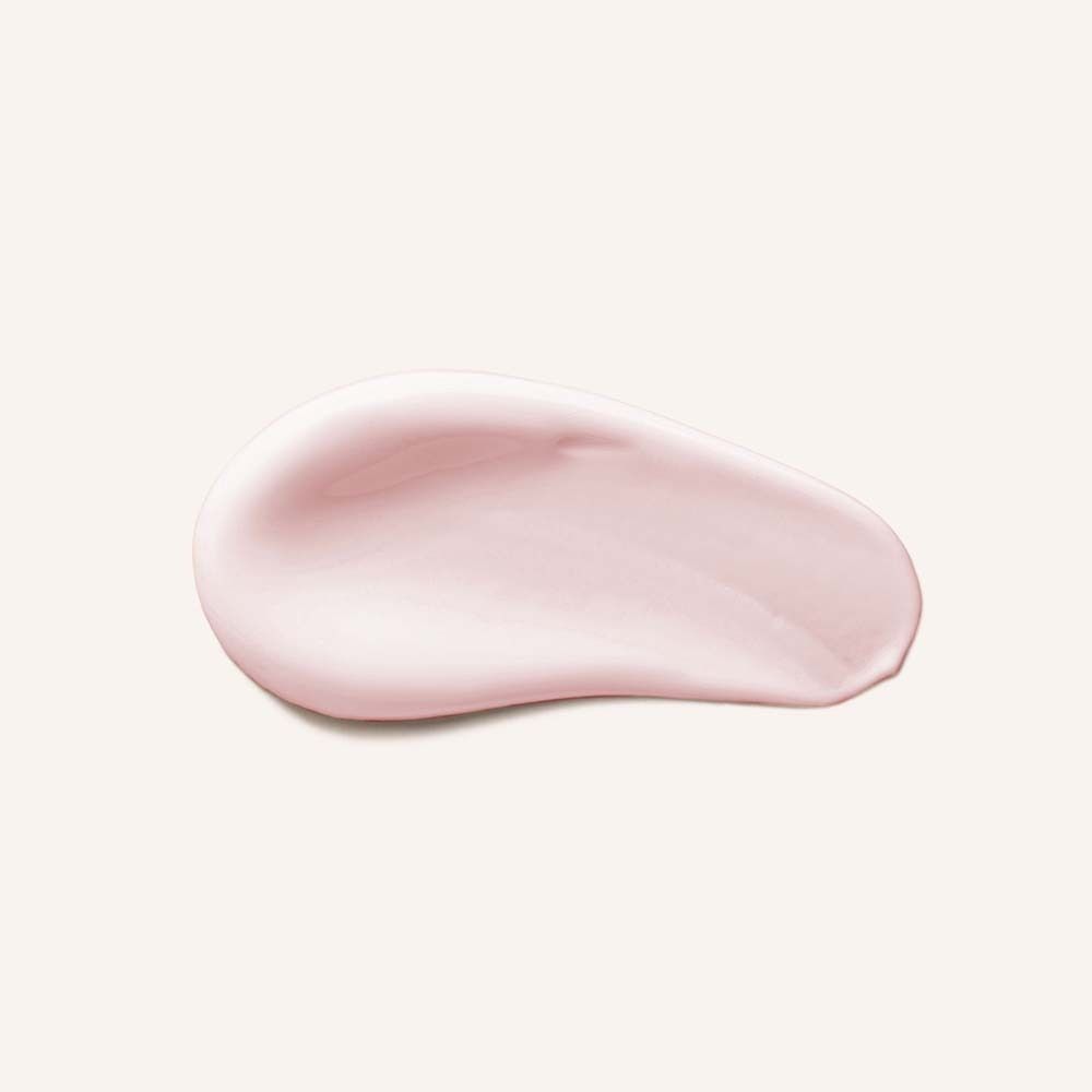 Mèche de conditionneur rose sur fond clair. Texture crémeuse, légèrement brillante.