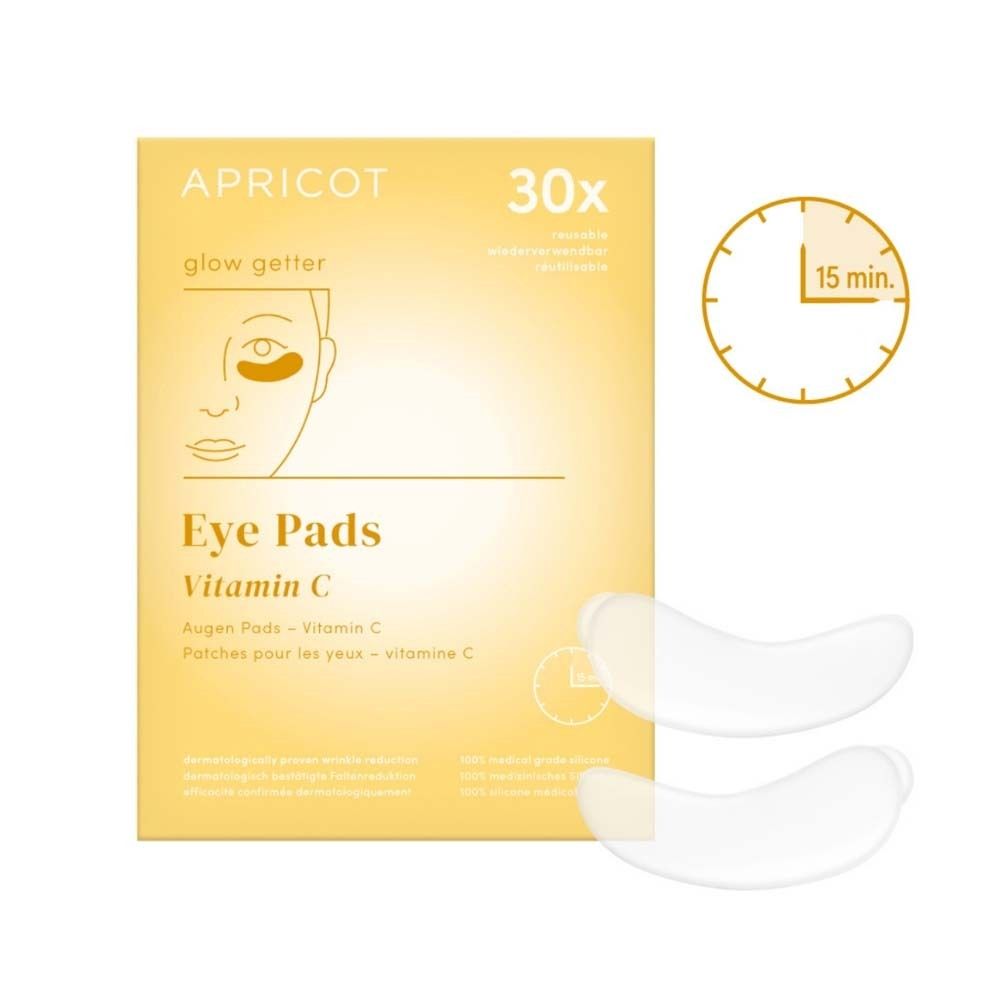 Paquet de coussinets pour les yeux. Contient 30 coussinets. Imprimé : APRICOT, Eye Pads Vitamin C. Deux coussinets à côté.