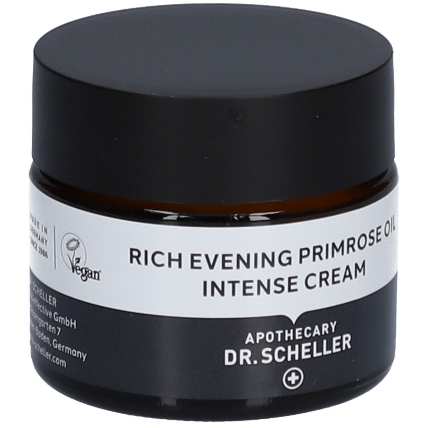 Pot de crème brun avec couvercle noir. Nom du produit sur étiquette blanche. Label vegan.