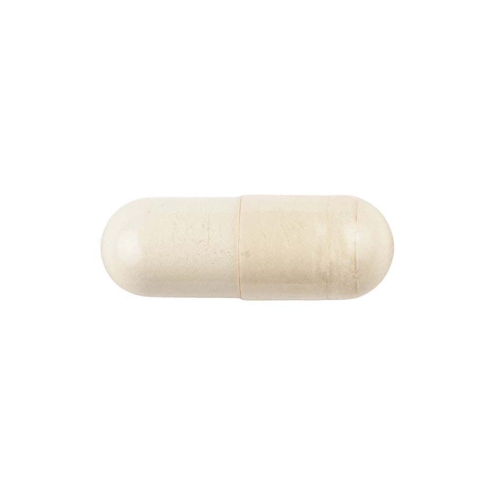 Une gélule allongée, couleur crème.