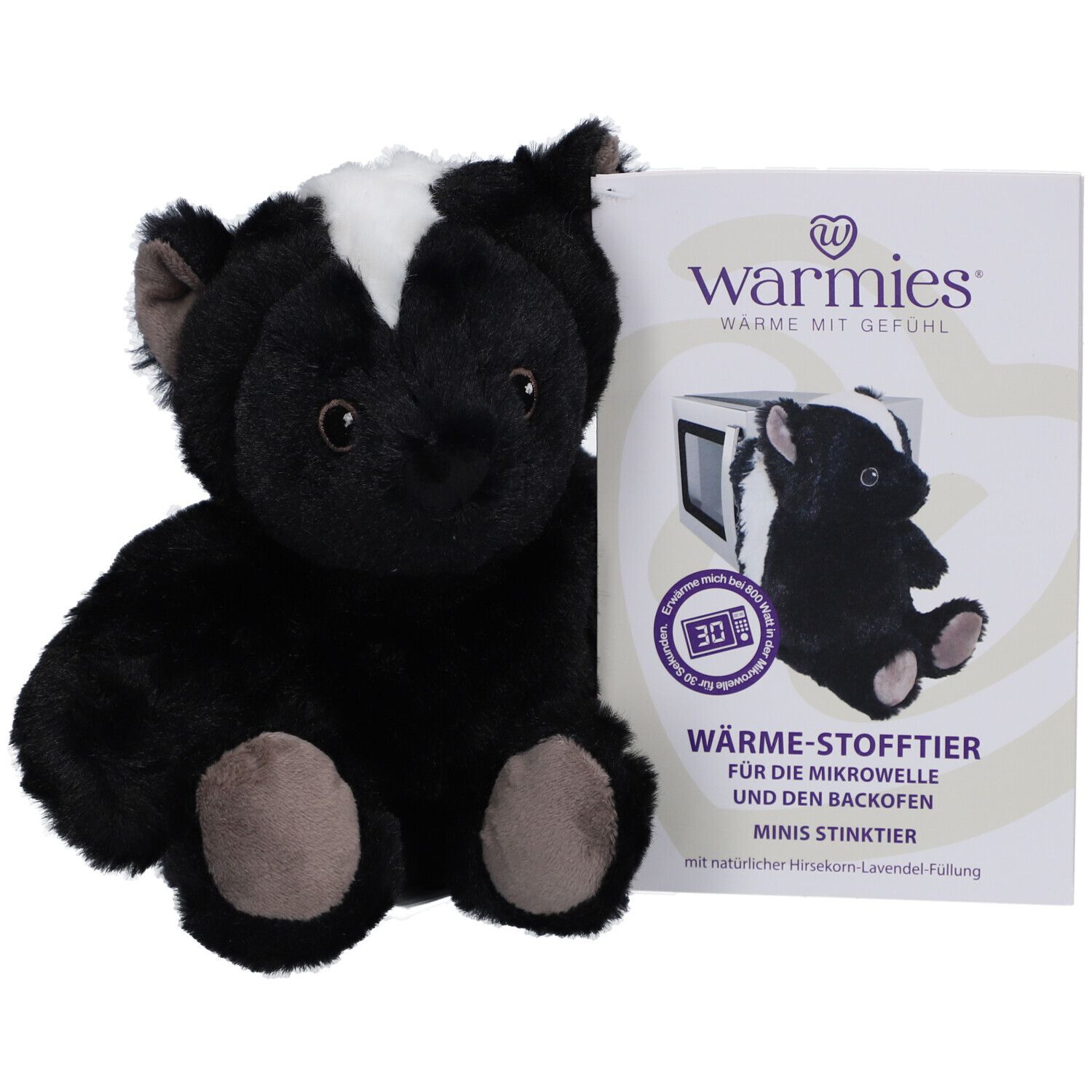 Peluche mouffette noire avec bande blanche, à côté d'un emballage avec symbole micro-ondes et texte.