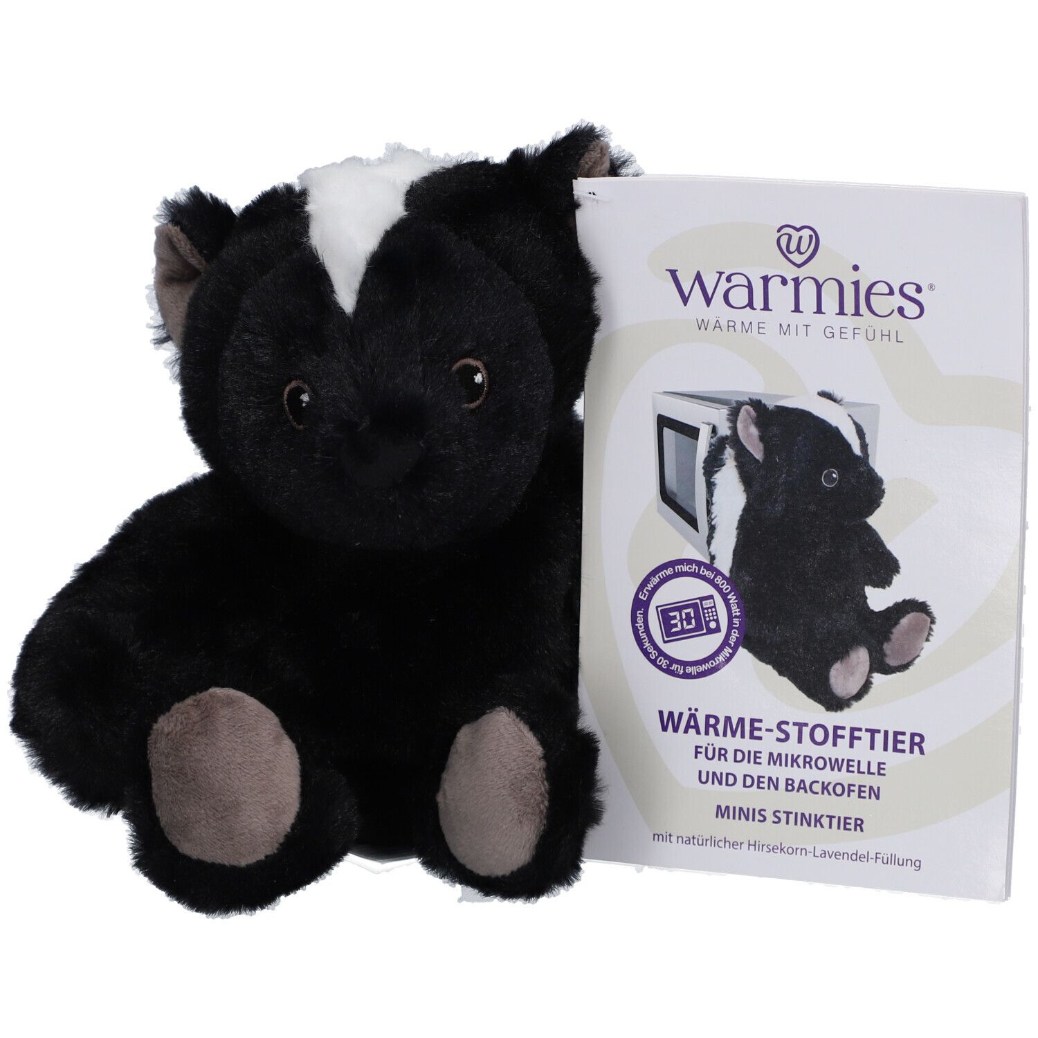 Peluche mouffette noire avec bande blanche sur la tête, à côté d'un emballage avec symbole micro-ondes.