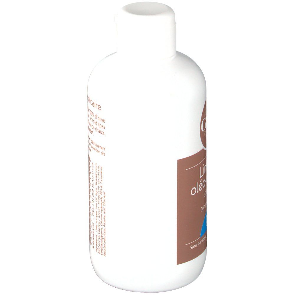 Flacon blanc avec étiquette marron. Inscription: Liniment oléo-calcaire. Avec bouchon.
