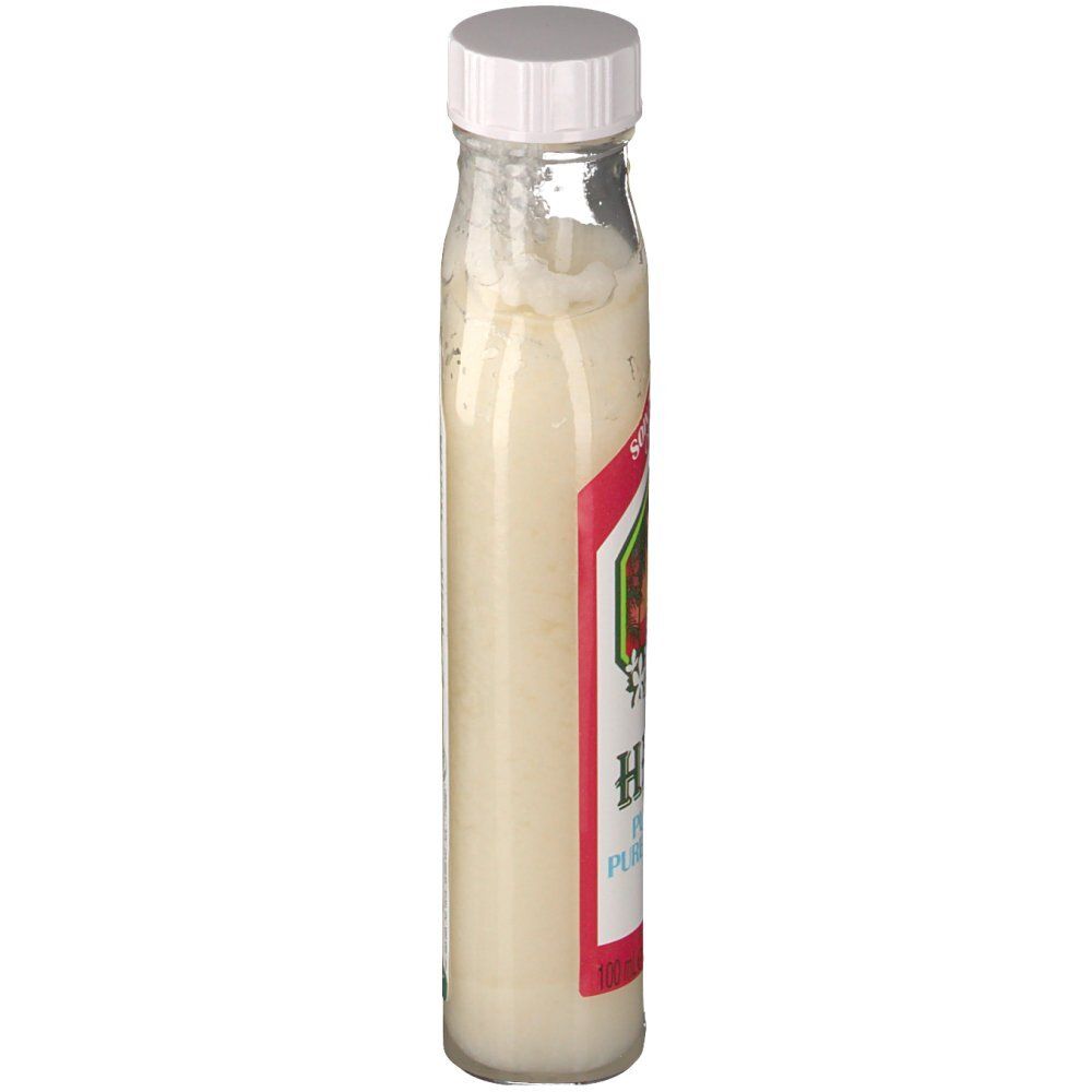 Flacon en verre avec bouchon blanc. Étiquette avec design rouge et vert. Contient un liquide crémeux.