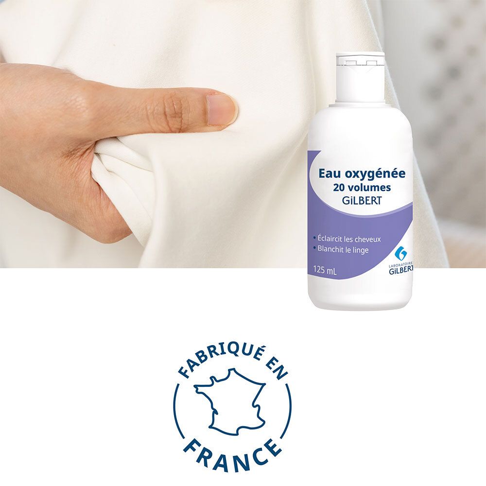 Flacon de produit à côté d'une main tenant du tissu. Texte: Eau oxygénée 20 volumes GILBERT. Fabriqué en France.