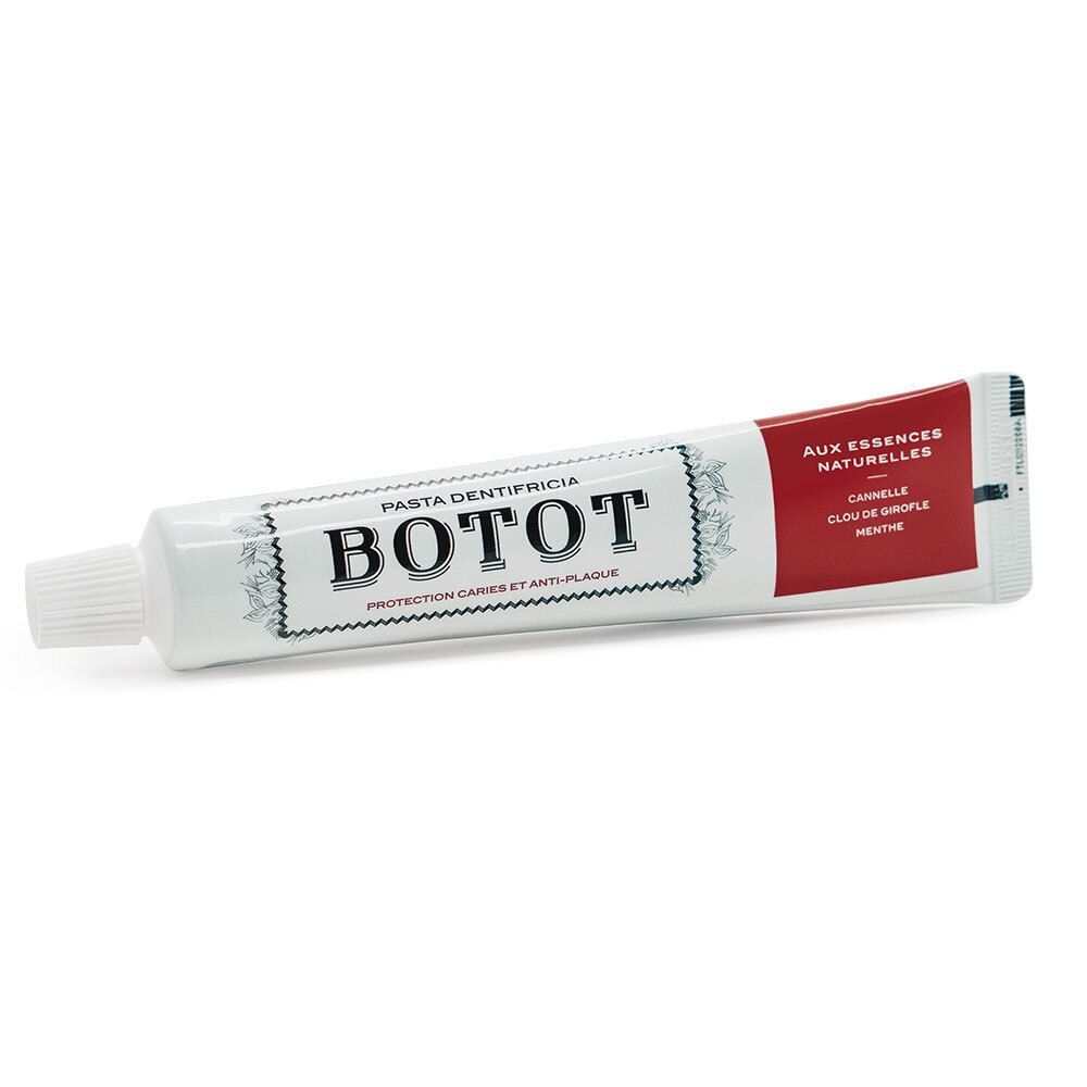 Tube de dentifrice blanche avec détails rouges. Inscription BOTOT et autres textes. Bouchon à vis.