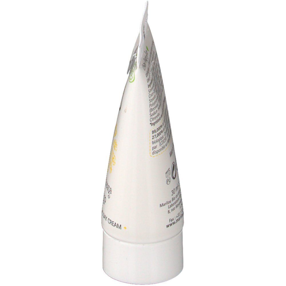 Vue latérale d'un tube blanc. Informations et texte imprimés visibles. La tête du tube est pliée.