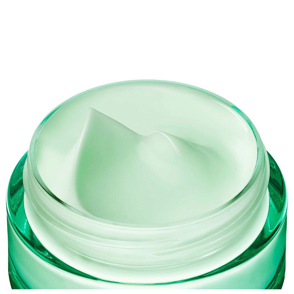 Gros plan du pot ouvert. Gel-crème vert visible.
