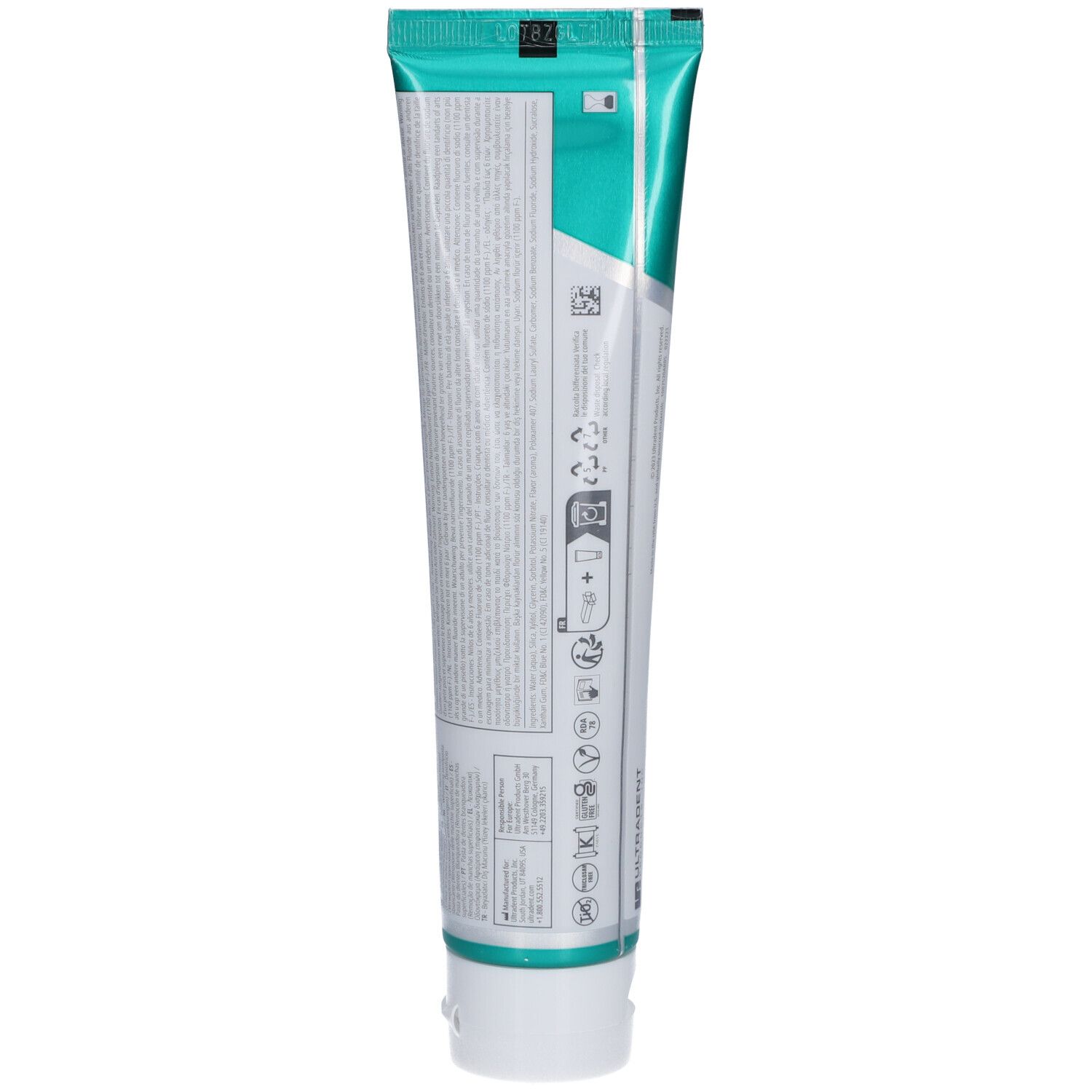 Achterkant van de tandpastatube. Bevat informatie en symbolen. Witte achtergrond met tekst.
