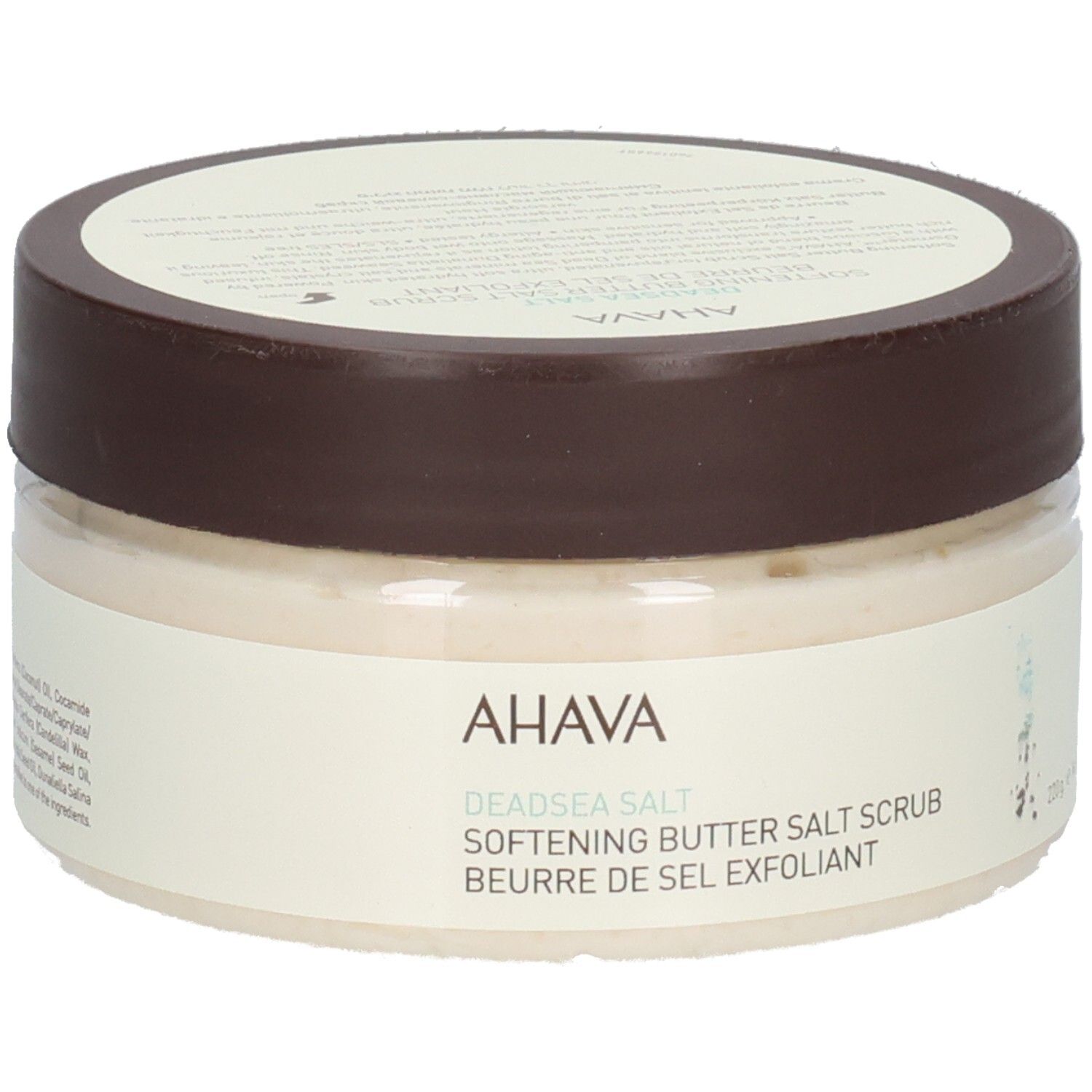 Ahava-product. Ronde, transparante pot met bruin deksel. Opschrift: AHAVA, Deadsea Salt, Softening Butter Salt Scrub, Beurre de Sel Exfoliant.