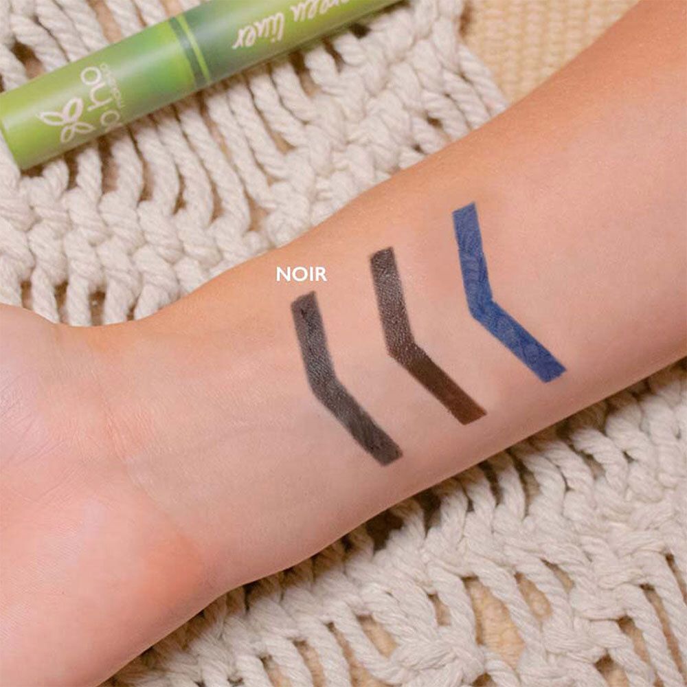 Bras avec trois traits d'eyeliner : noir, marron, bleu. Nom du produit : BOHO Green Liner. Inscription : NOIR.